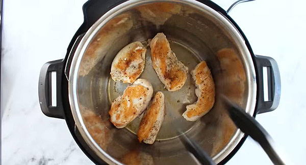 This image shows the chicken tenders being sauteed in the instant pot.
