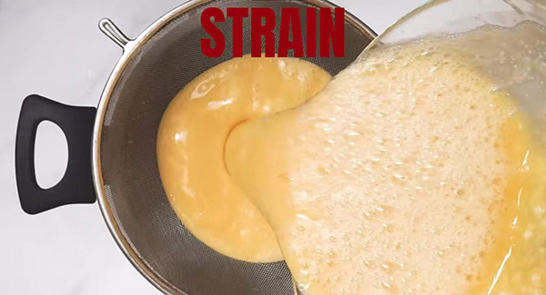 This image shows the egg mixture being strained.