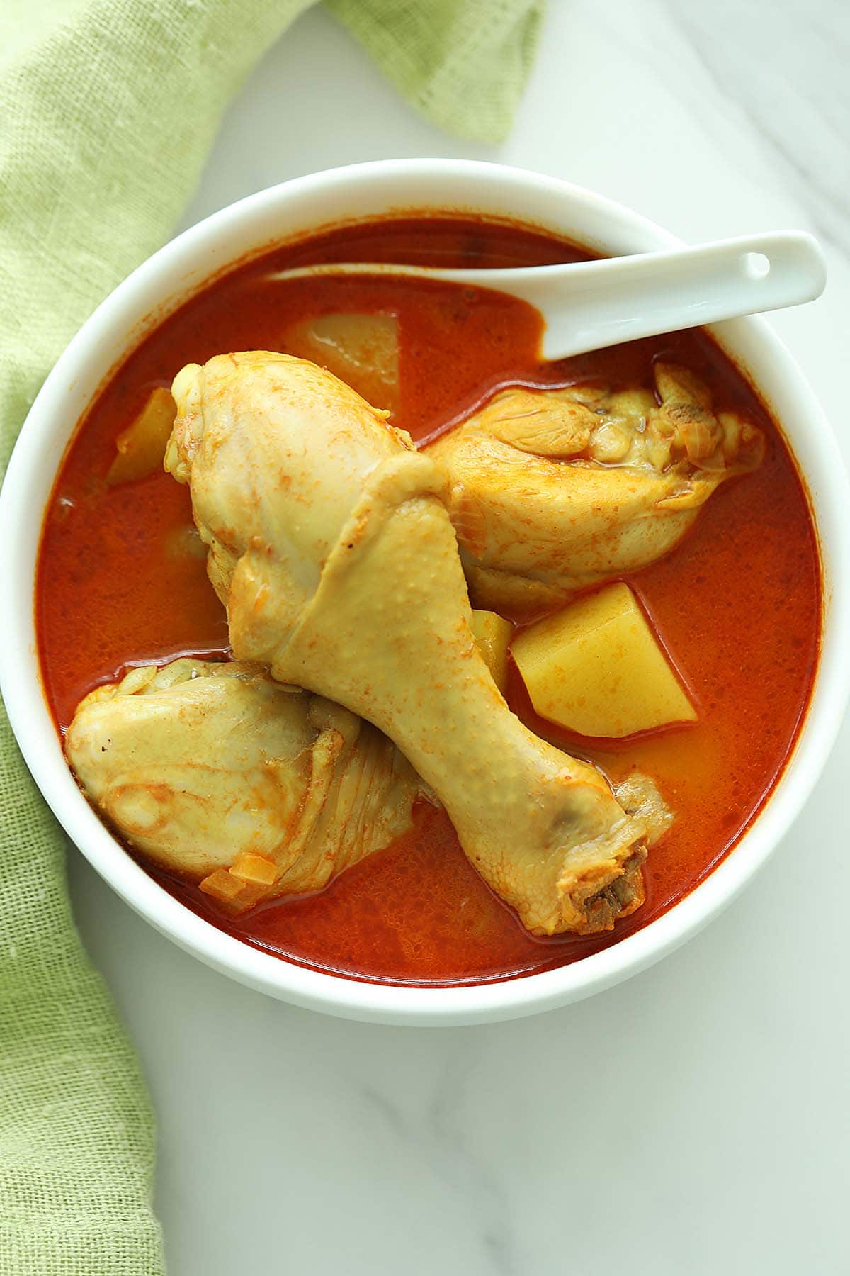 Curry chicken legs in serving bowl. 