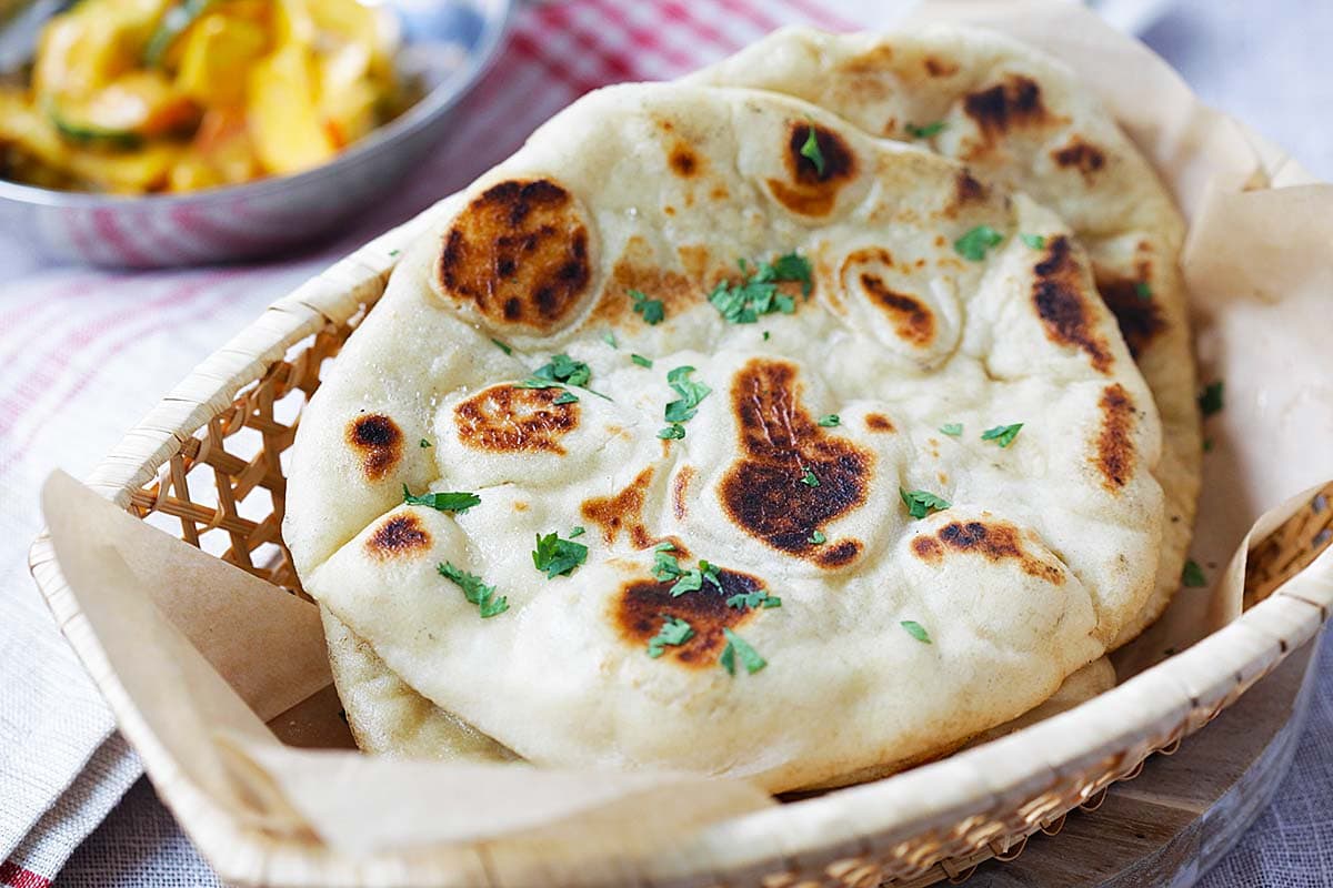 Fresh-off-the-skillet naan bread brushed with melted butter. 