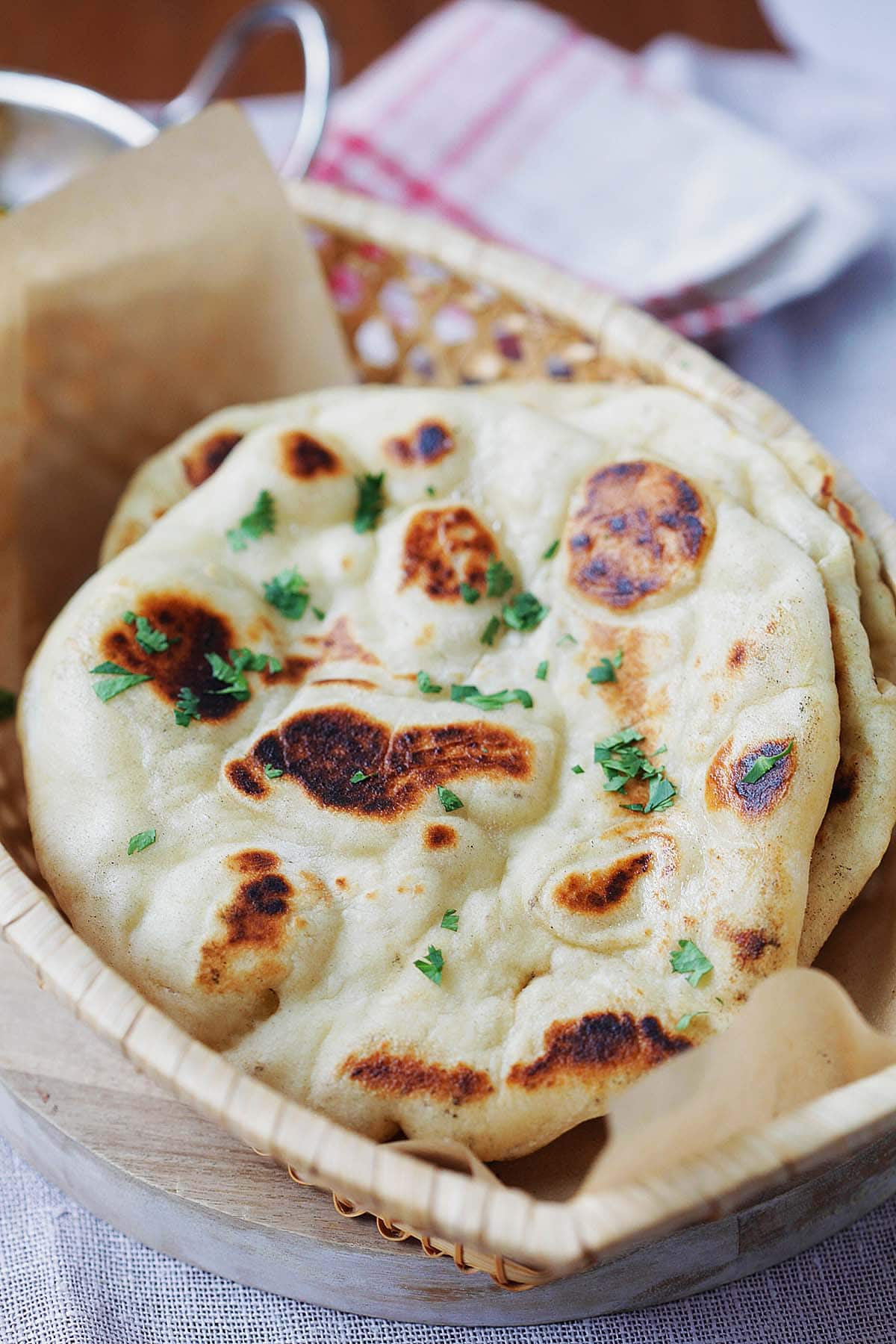 Soft and puffy naan bread topped with chopped cilantro. 