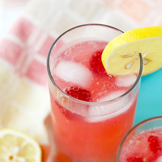 Fresh raspberry lemonade served with a slice of lemon. 
