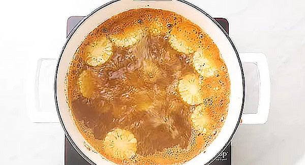 Water boiling with potatoes, corn, and Old bay seasoning.