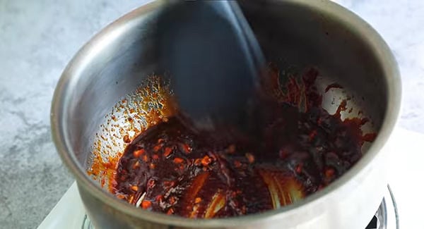 Spicy chicken wing sauce cooked in a pot.
