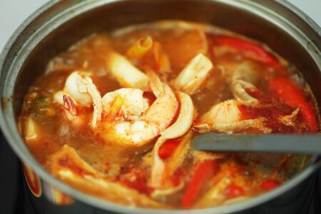 Cooked shrimp in a pot of soup.