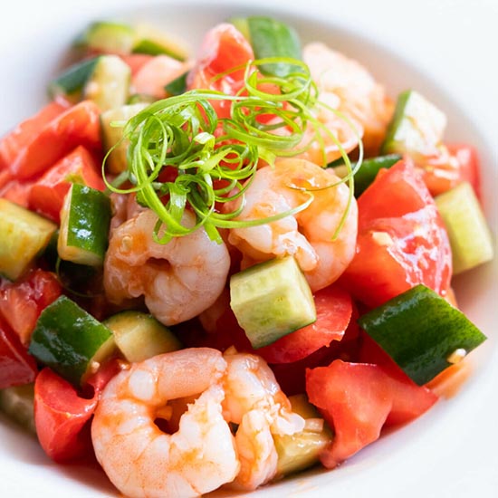 Tomato and shrimp salad served in a plate.