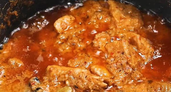 Chicken rendang simmering in the skillet. 