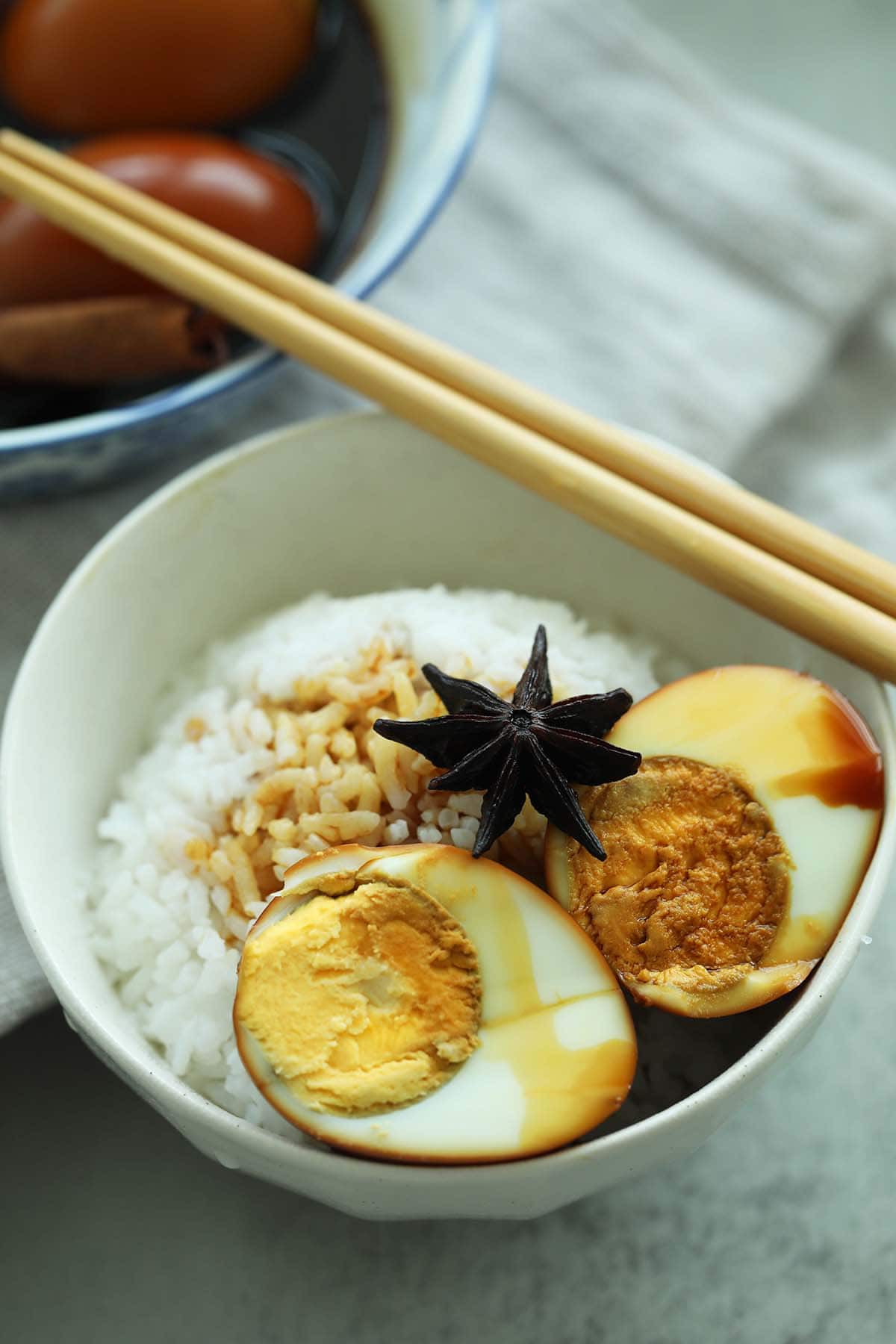 Braised hard boiled egg in soy sauce served with rice.