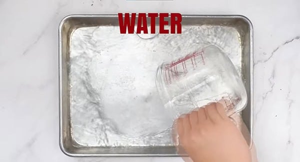 Water being poured into a baking tray.