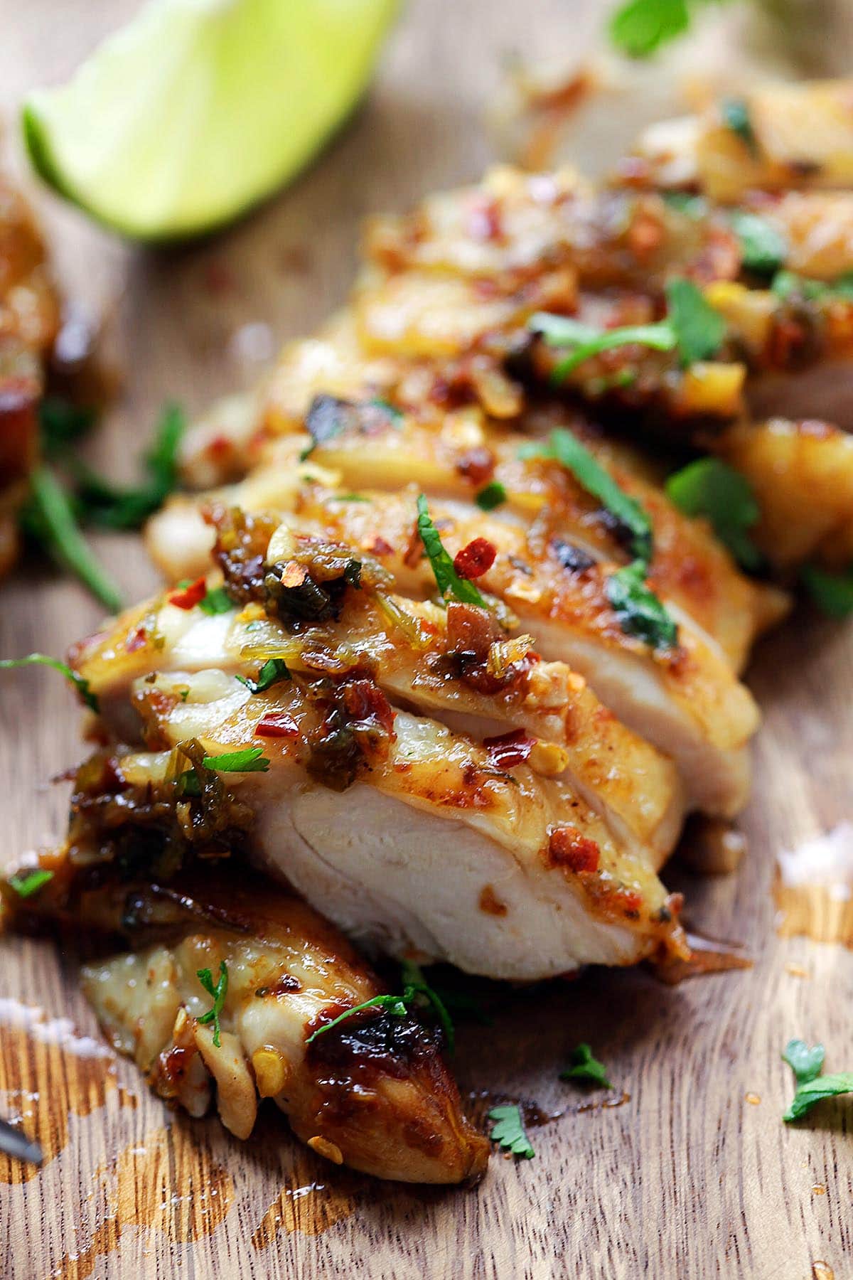 Grilled cilantro lime chicken served with lime wedges.