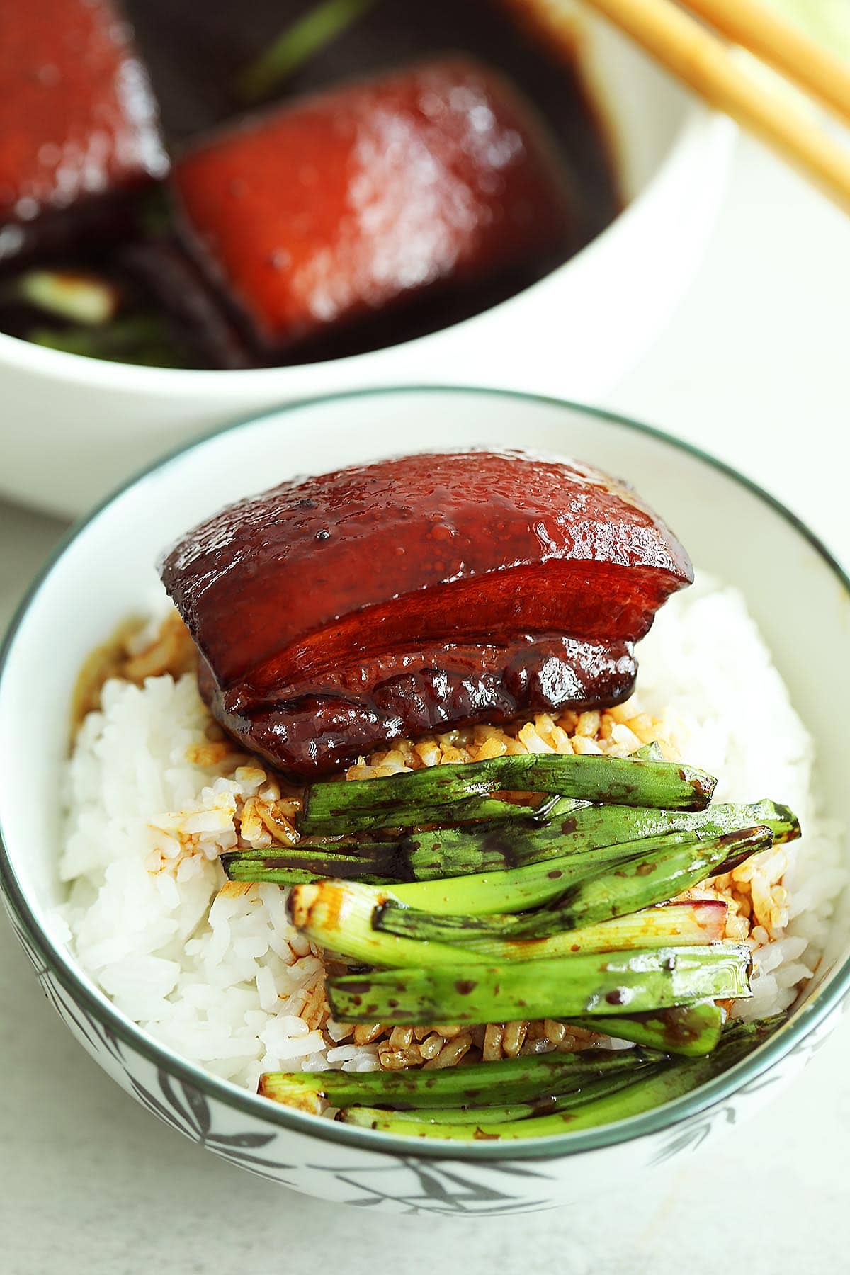 Dongpo pork (Chinese braised pork belly) with steamed rice in a bowl. 