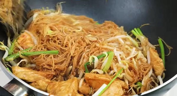 Fried rice vermicelli noodles in a wok. 