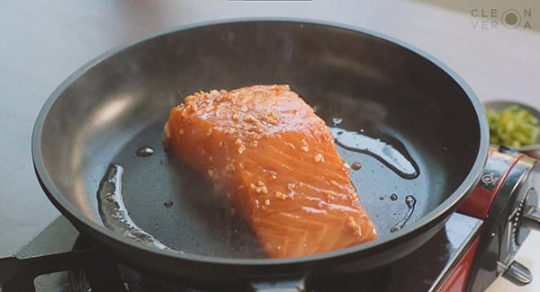 Salmon on a skillet with sesame oil. 