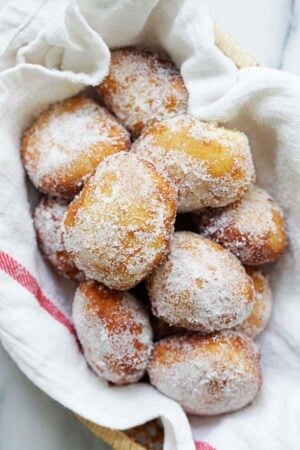 Easy and quick malasadas Portuguese donuts coated with granulated sugar.