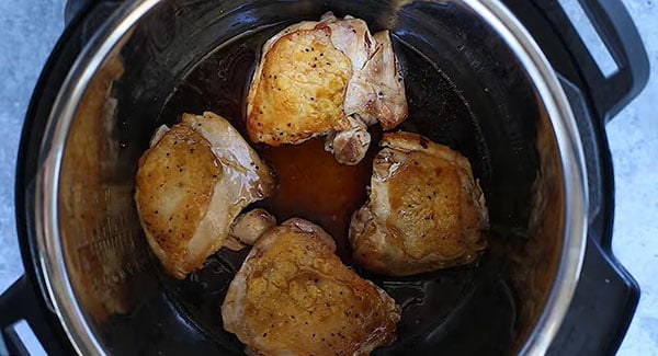Browned chicken thighs with the honey garlic sauce in an instant pot. 