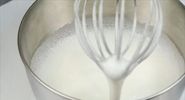 Meringue with soft peaks in a stand mixer. 
