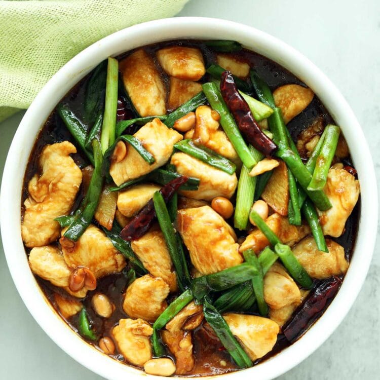 Homemade Kung Pao Chicken served in a rice bowl with steamed rice.