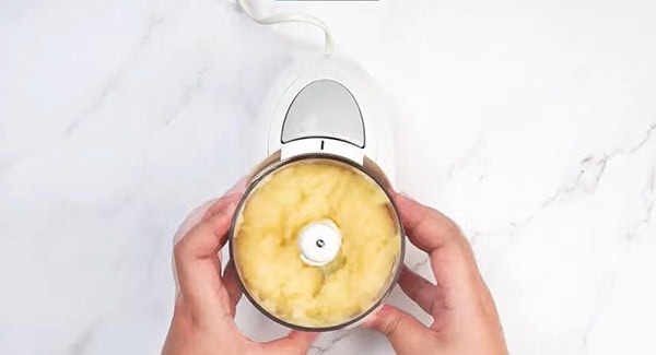 Blended pineapple in a food processor. 