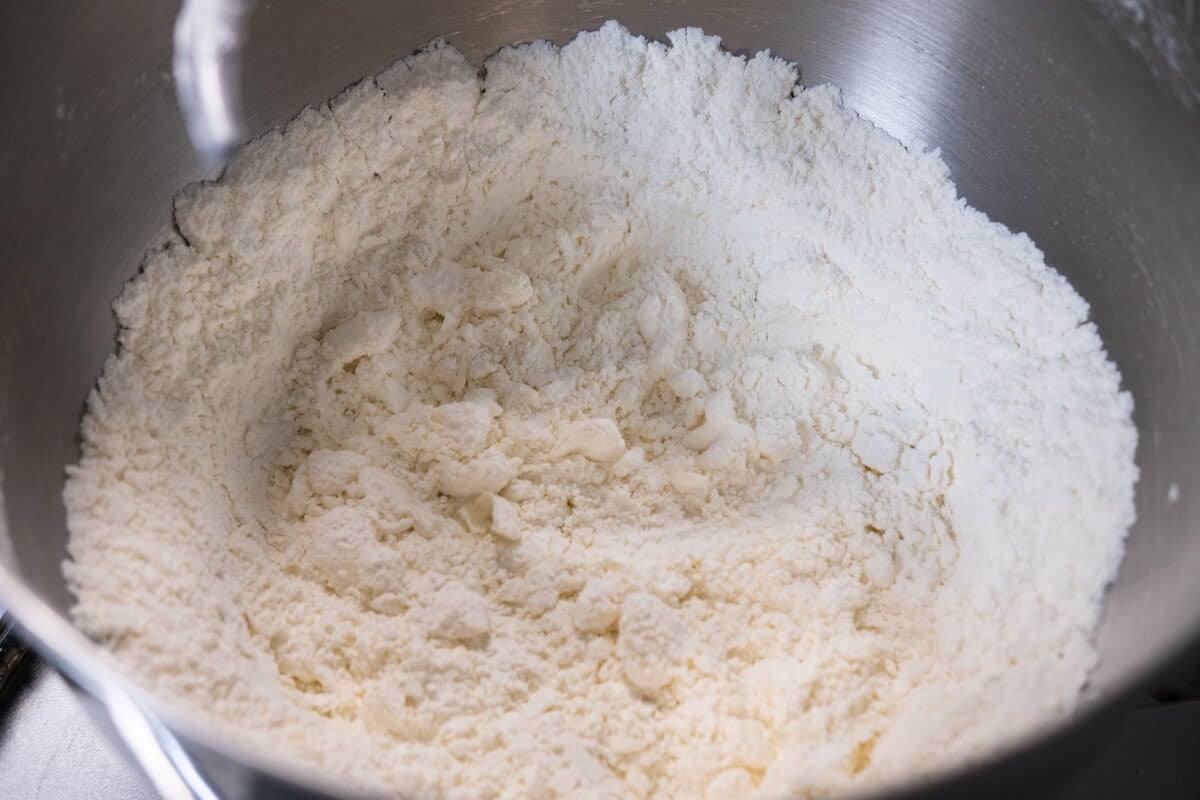 Combine flour, salt, sugar, and 1/4 cup of the ghee in the bowl of a stand mixer.