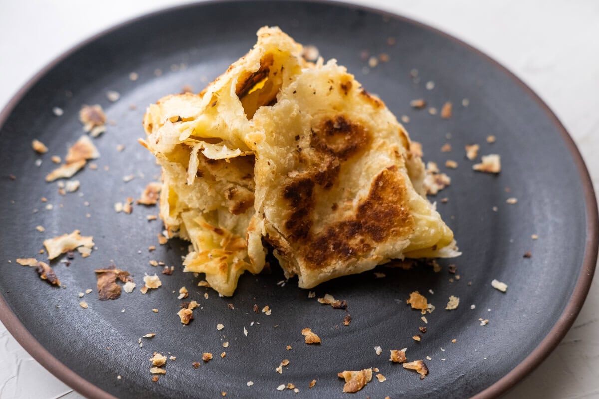 Transfer the breads to a work surface, and then use a clapping motion (careful, it will be hot), slapping the bread together between your hands to separate the layers.