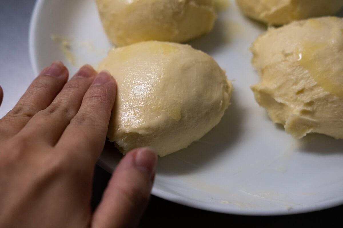 Transfer the dough out and cut into eight equal pieces, about 4 oz. each (113 g), coat the dough with ghee. 