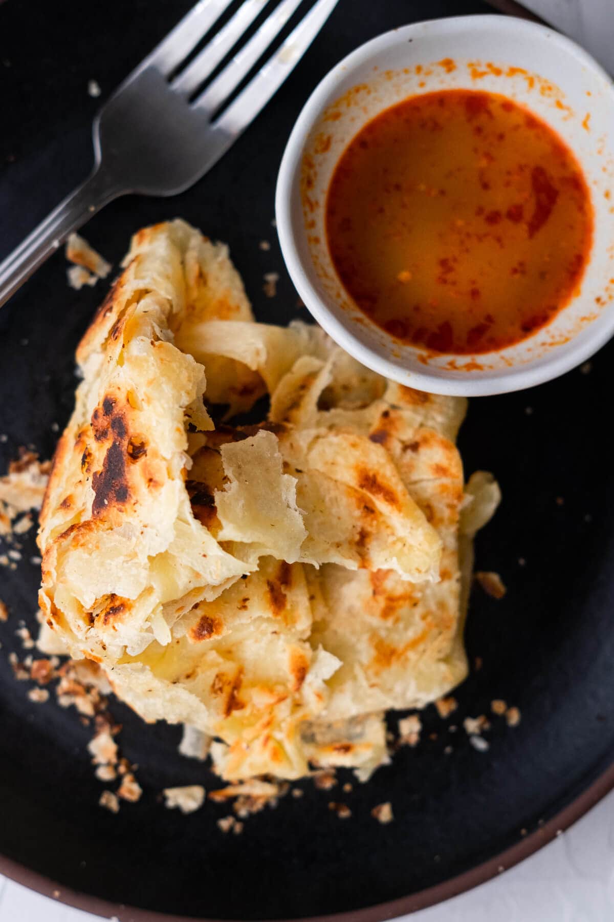 Roti canai served with curry. 