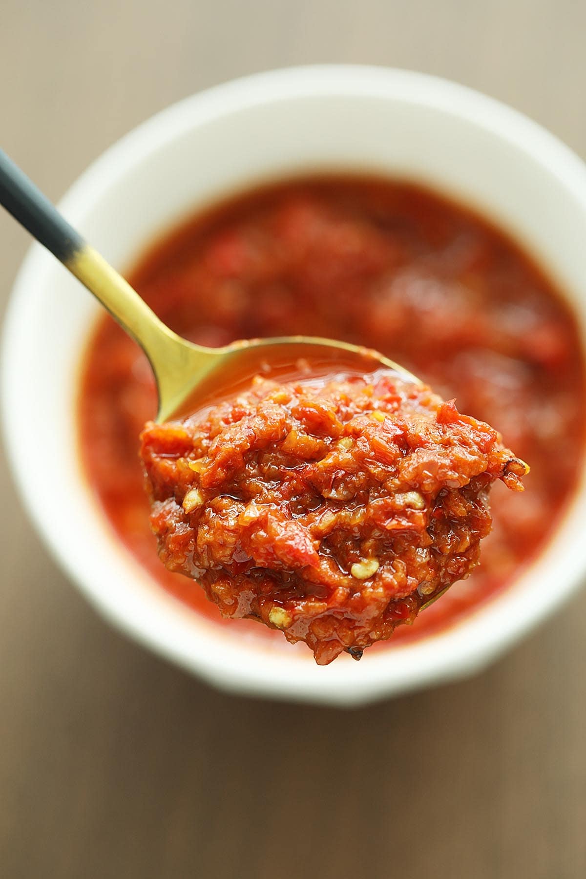 A spoonful of red and fiery hot sambal. 