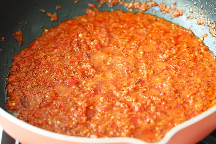 cooking the sambal until oil separates from it.