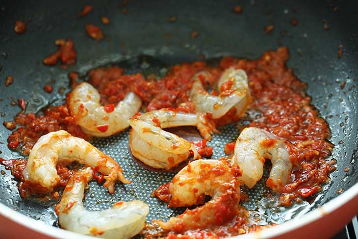 Shrimp cooked with sambal in a wok. 