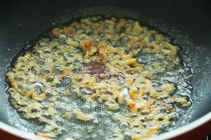 Dried Shrimps  being fried in a wok.