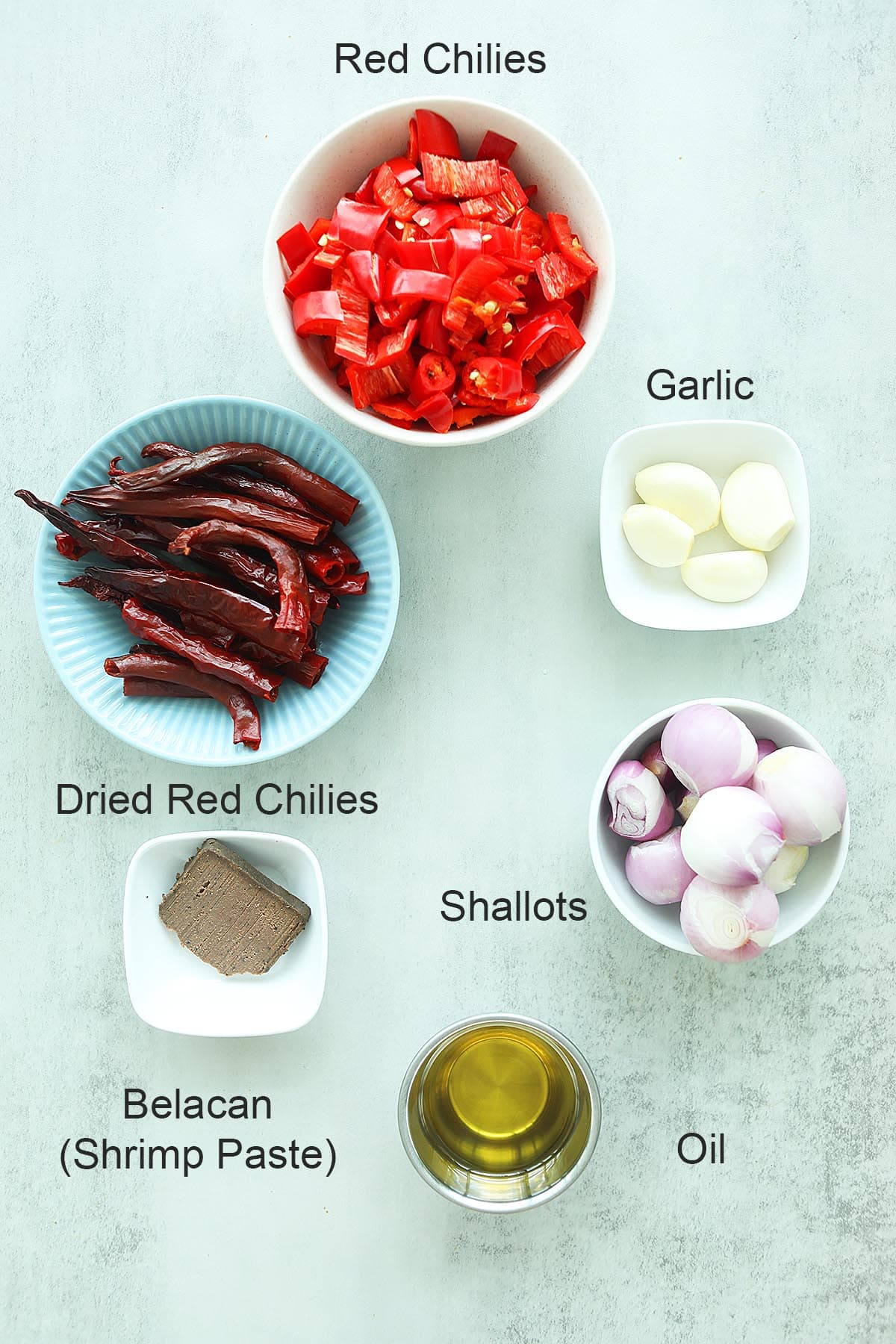 Ingredients for sambal includes fresh red chilies, dried red chilies, garlic, shallots and belacan. 