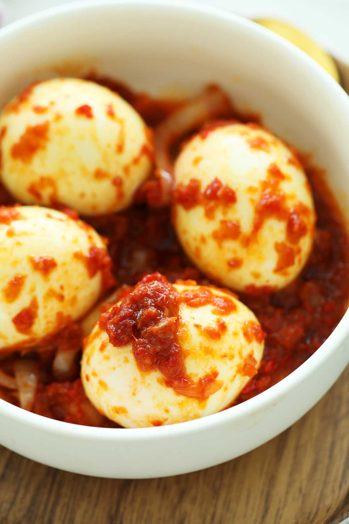 Close up shot of Hard boiled eggs covered in a sweet, spicy and savory sambal!