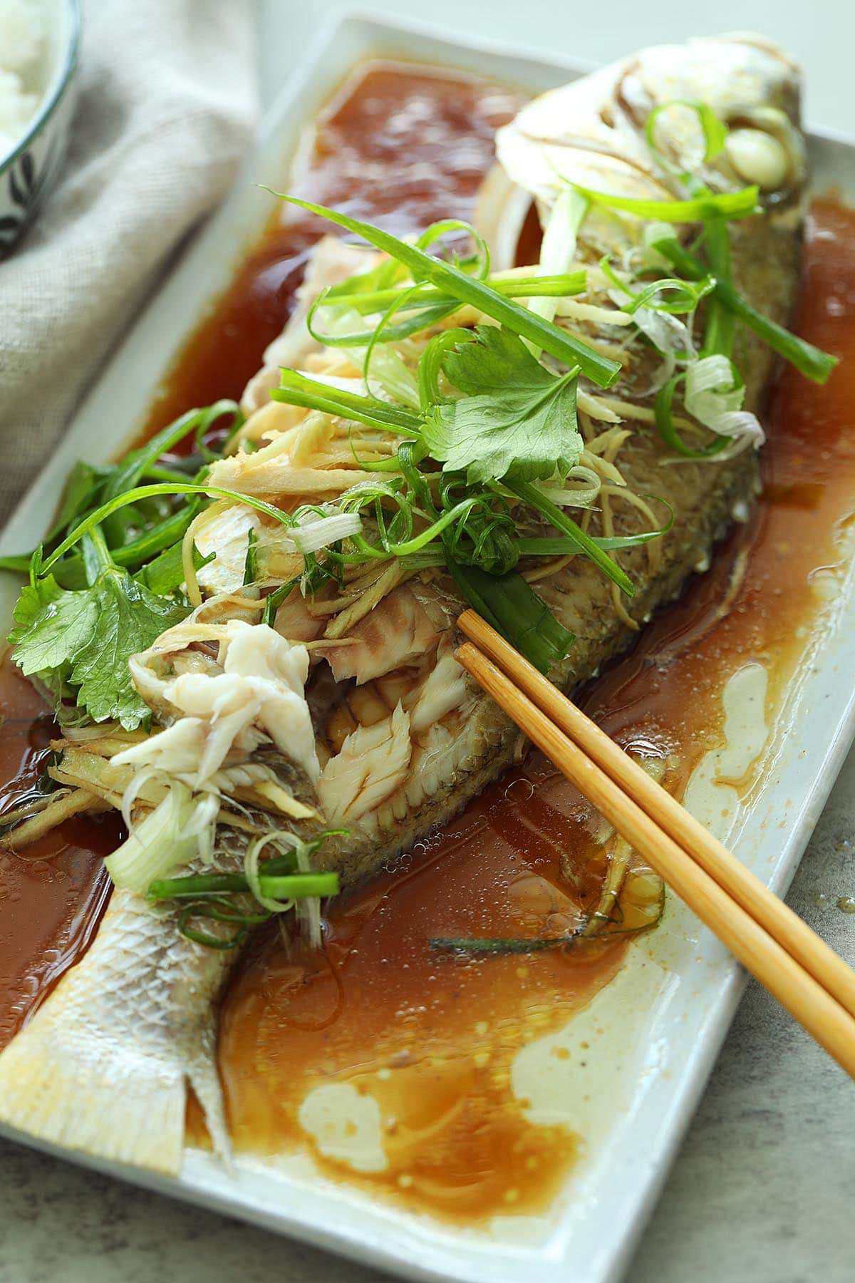 Chinese style steamed fish served with a bowl of rice. 