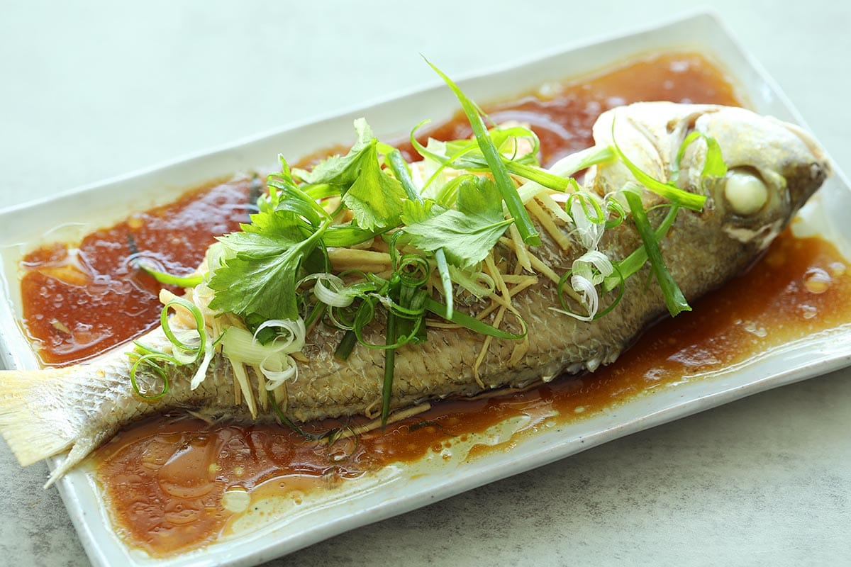 Steamed fish on a plate, ready for serving. 