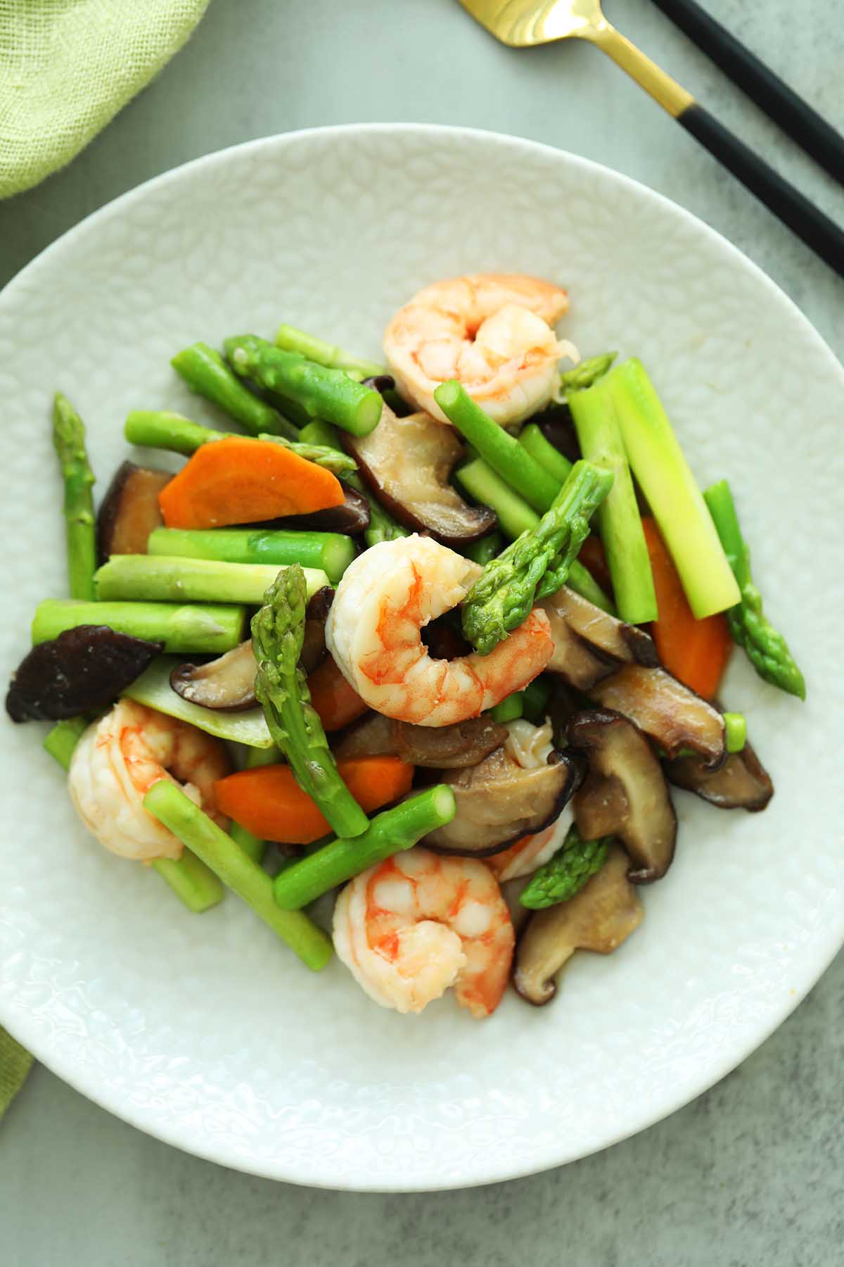 Delicious Stir-fried Asparagus with shrimp served on a plate.