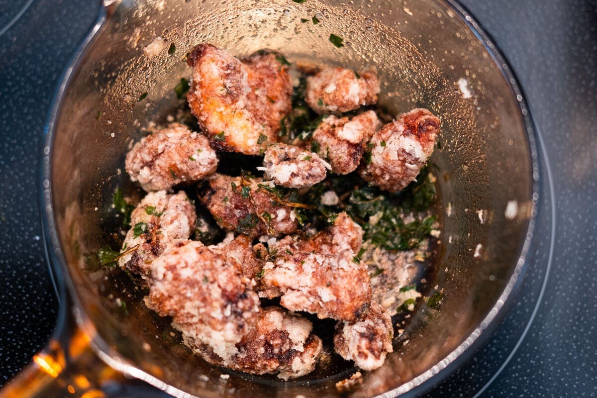 Add the deep fried chicken breast and basil leaves to a pan and toss well with pepper salt. 