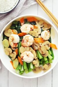 Choy sum with shrimp and mushroom on a plate.