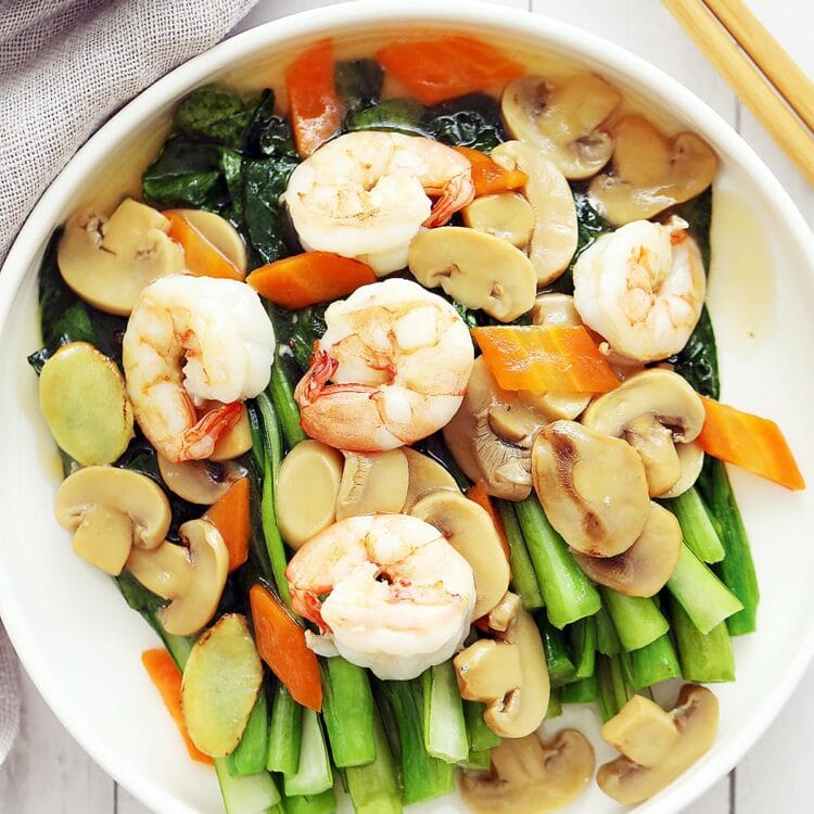 Choy sum with shrimp and mushroom on a plate.