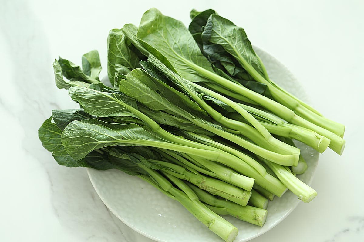 Fresh choy sum or yu choy sum (you choy sum) on a plate. 