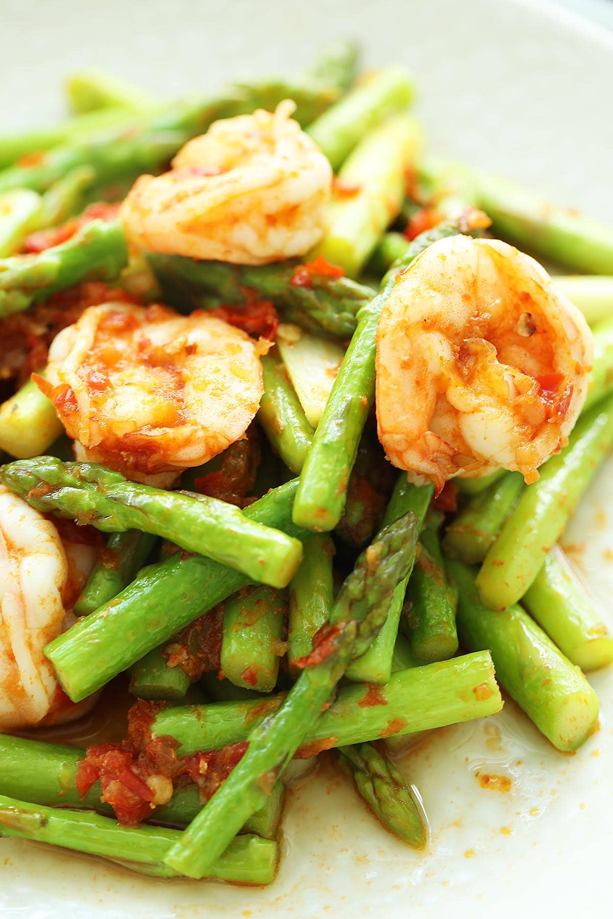 Spicy asparagus with shrimp served on a plate. 