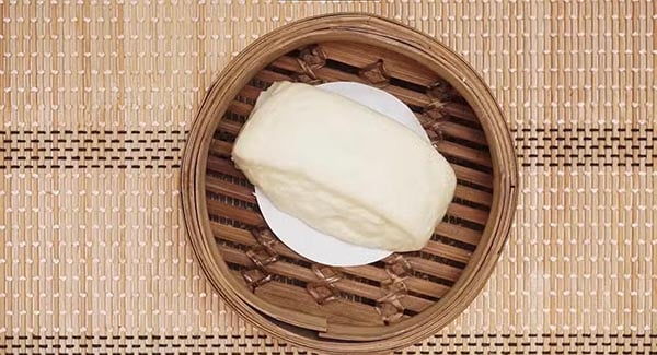 Steamed buns in a bamboo steamer. 