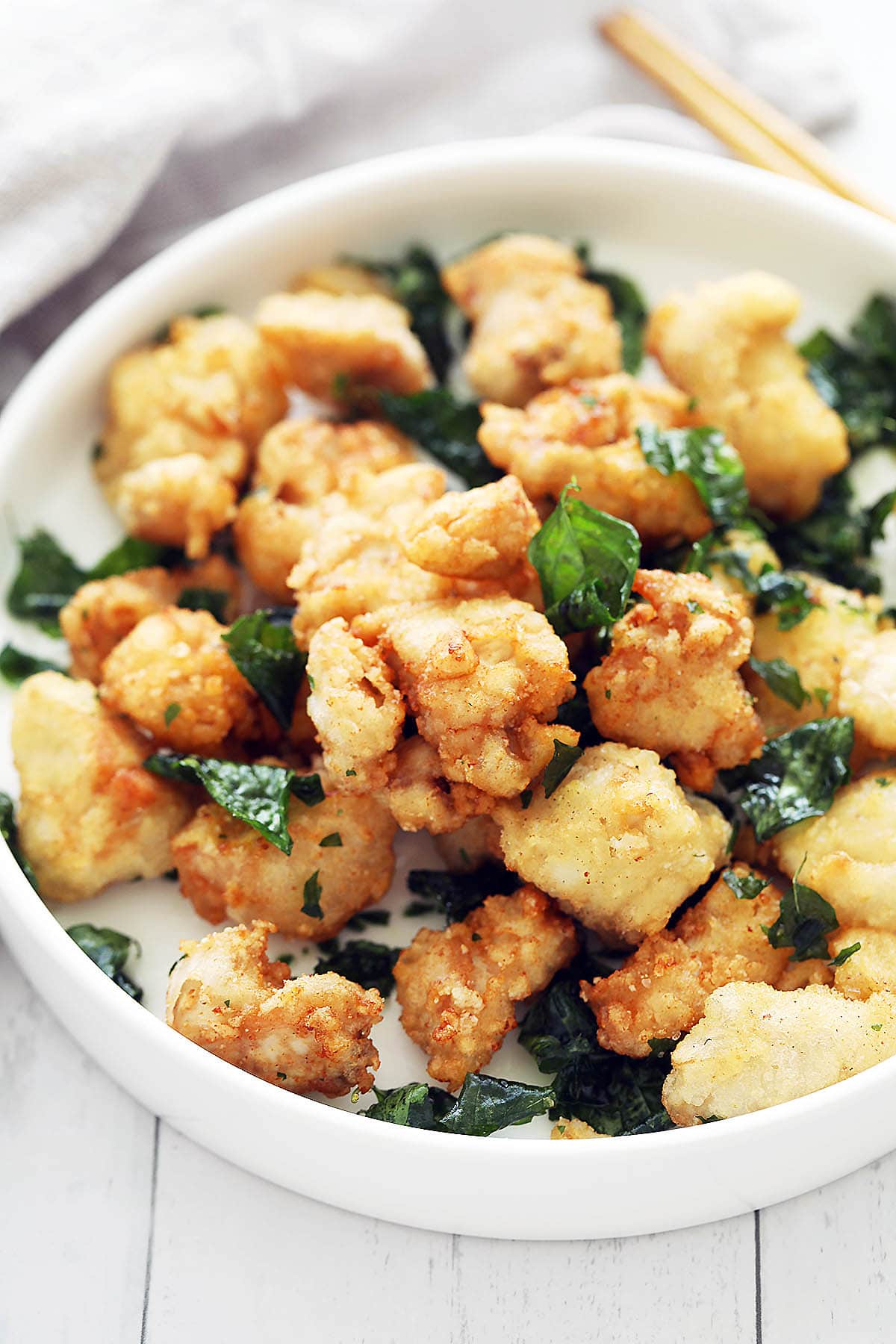 Easy homemade Taiwanese popcorn chicken nuggets with basil leaves. 