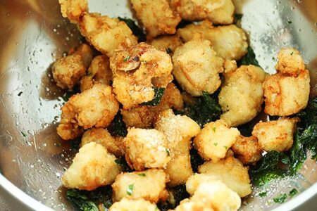 Deep fried Taiwanese salt and pepper chicken tossed with pepper salt in a big bowl. 