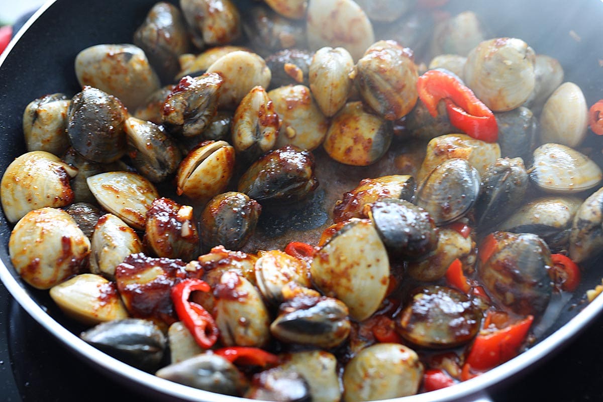 Cooking Thai clams in a skillet. 