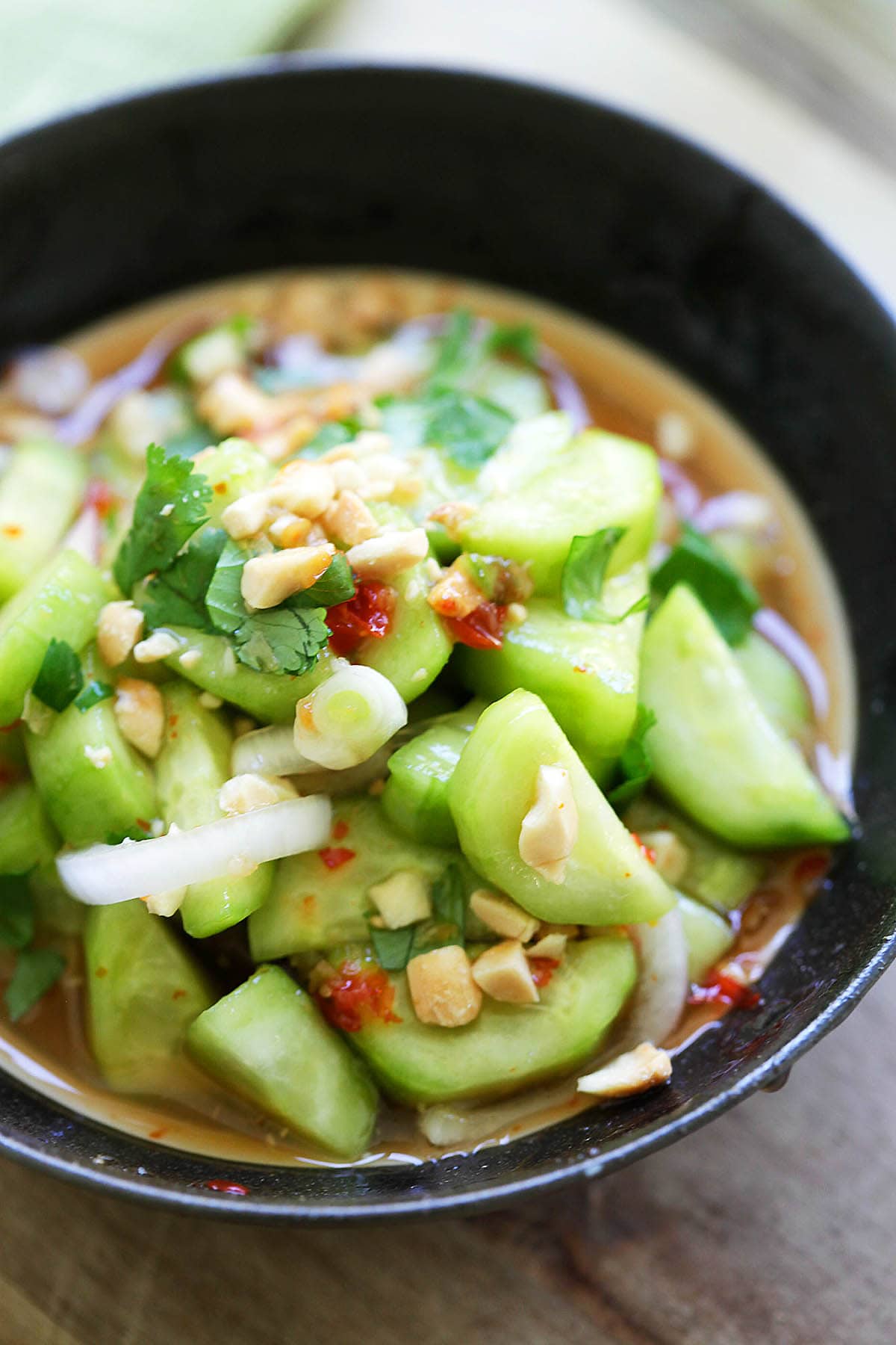 Spicy and sweet Thai cucumber salad with peanuts and in a dressing. 