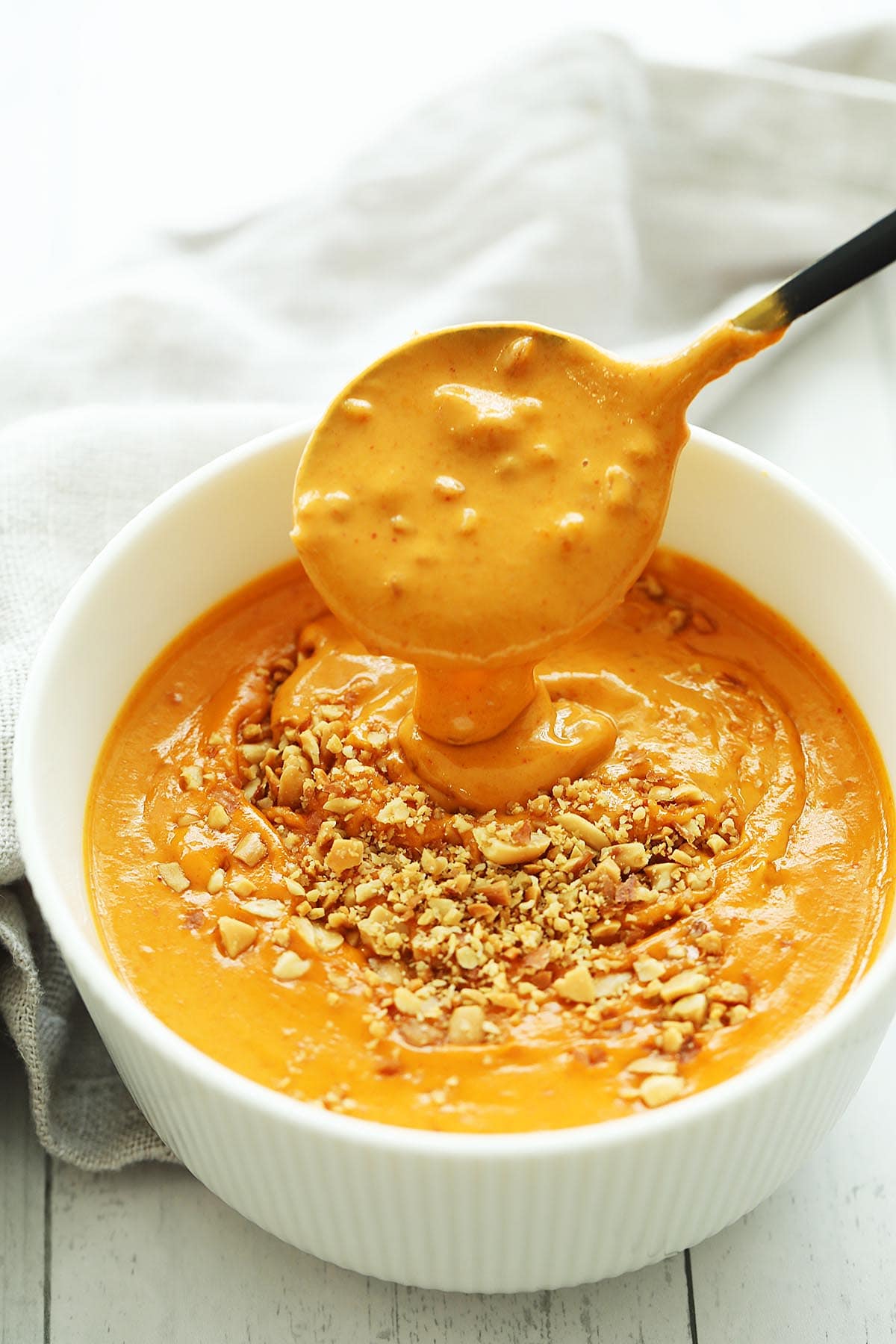 Spicy peanut sauce on a spoon. 