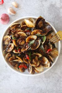 Kam heong clams on a plate.