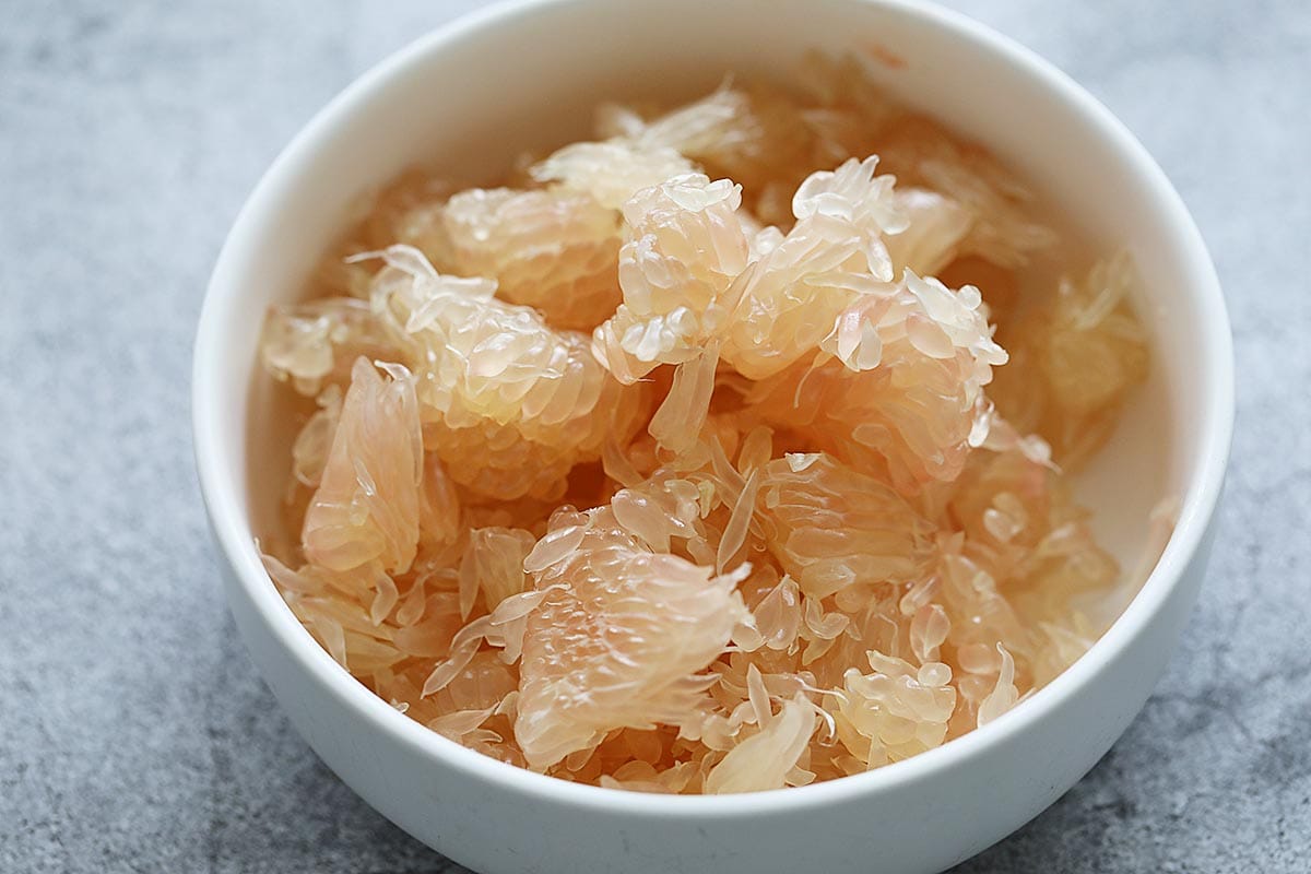 Fresh pomelo fruit on a plate.