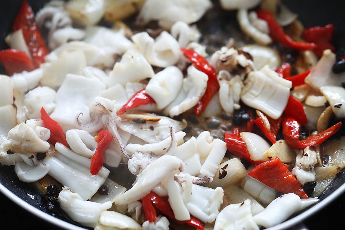 Cooking squid in black bean sauce. 