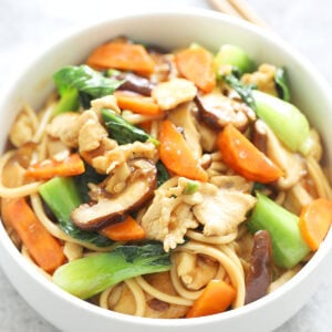 Authentic chicken lo mein stir fry with a pair of chopsticks.